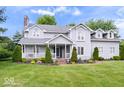 Two-story home with well-manicured landscaping, a covered porch, and beautiful curb appeal at 7056 E 171St St, Noblesville, IN 46062