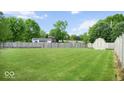 Expansive backyard featuring a well-maintained lawn, wooden fence, and a storage shed at 7242 Blue Ridge Dr, Noblesville, IN 46062