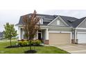 Inviting home exterior showcasing a well-maintained lawn and an attached front-entry garage at 747 Tuxedo Dr, Westfield, IN 46074