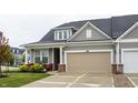 Attractive home with neutral-colored siding, an attached garage, and a charming front sitting area at 747 Tuxedo Dr, Westfield, IN 46074