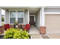 Inviting front porch with outdoor seating, decorative plants, and a welcoming front door at 747 Tuxedo Dr, Westfield, IN 46074