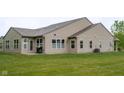 Spacious backyard featuring sliding door to backyard, grill, and ample sunlight and green grass at 808 Heartland Ln, Brownsburg, IN 46112