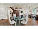 Elegant dining room with glass table and view into the adjoining living area at 847 N Park Ave, Indianapolis, IN 46202