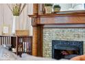 Close up of an ornate fireplace with decorative tile and a wood mantel at 847 N Park Ave, Indianapolis, IN 46202