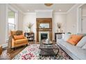 Cozy living room with a decorative fireplace, a comfortable sofa, and a colorful rug at 847 N Park Ave, Indianapolis, IN 46202