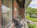 Inviting front porch area with outdoor seating at 914 N College Ave, Indianapolis, IN 46202