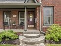 Inviting front porch with seating and stylish brickwork at 914 N College Ave, Indianapolis, IN 46202