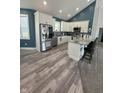 Bright kitchen with stainless steel appliances, granite countertops, and hardwood floors at 951 N Maiellen Dr, Greenfield, IN 46140