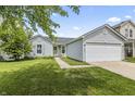 Charming single-story home with a two-car garage, well-maintained lawn, and welcoming curb appeal at 9560 W Campfire Dr, Pendleton, IN 46064