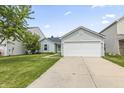 Charming single-story home with a two-car garage, well-maintained lawn, and inviting driveway at 9560 W Campfire Dr, Pendleton, IN 46064