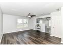 Open living room featuring sleek wood-look floors, a ceiling fan, and bright natural light at 9676 W Constellation Dr, Pendleton, IN 46064