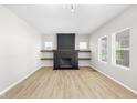 Bright living room with a fireplace and light wood flooring, offering a cozy and modern feel at 1016 Churchman Ave, Indianapolis, IN 46203