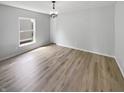 Bright bedroom with new floors, a modern light fixture, and a large window at 10366 Camby Xing, Fishers, IN 46038
