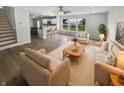 Bright living room featuring hardwood floors, neutral colors, and an open floor plan to the kitchen at 10366 Camby Xing, Fishers, IN 46038