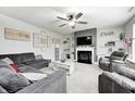 Inviting living room boasts plush seating, fireplace, ceiling fan, and decorative shelves at 10447 Pintail Ln, Indianapolis, IN 46239