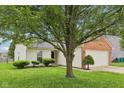 Inviting home exterior featuring lush lawn and mature tree, providing shade and curb appeal at 1093 Country Meadow Ct, Franklin, IN 46131