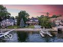 Spectacular waterfront home with private beach, boat dock, and lush greenery in a serene setting at 11715 Landings Dr, Indianapolis, IN 46256