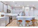 Modern kitchen featuring stainless steel appliances, large island, and pendant lighting, set against light grey cabinetry at 13217 E 131St St, Fishers, IN 46037