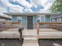 Charming home featuring a spacious wooden front porch with a mailbox and steps leading up to the inviting entrance at 1415 Lawton Ave, Indianapolis, IN 46203