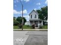 View of a quaint two-story home featuring a white picket fence at 1517 S Reisner St, Indianapolis, IN 46221