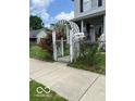 View of home featuring a white gate and flowers at 1517 S Reisner St, Indianapolis, IN 46221