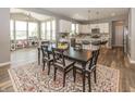 Dining area featuring a stylish rug, modern lighting, and an open view to the kitchen at 16419 Connolly Dr, Westfield, IN 46074