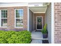 Inviting front entrance with a decorative wreath, brick facade, and green landscaping at 16419 Connolly Dr, Westfield, IN 46074
