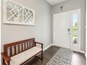 Inviting foyer with a decorative mirror, a cozy bench, and a stylish rug, creating a welcoming entrance at 1807 Orchard Dr, Fortville, IN 46040