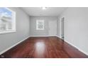 Bright living room featuring hardwood floors and neutral paint, illuminated by natural light at 2030 Houston St, Indianapolis, IN 46218