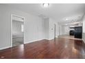 Spacious living area with hardwood floors and an open layout, leading to the kitchen and other rooms at 2030 Houston St, Indianapolis, IN 46218