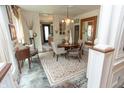 Bright dining room with neutral paint, hardwood floors and charming chandelier at 232 S Audubon Rd, Indianapolis, IN 46219