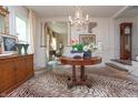 Elegant foyer featuring a decorative chandelier, ornate accents, and a grand tiger print rug at 232 S Audubon Rd, Indianapolis, IN 46219
