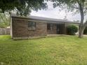 Brick single story house with front yard and landscaping. Windows and entryway visible at 3055 Pawnee Dr, Indianapolis, IN 46235