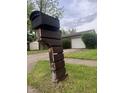 Street-side mailbox with the house numbers visible and a blurry view of the house in the background at 3055 Pawnee Dr, Indianapolis, IN 46235