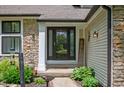 Inviting front entrance with decorative landscaping, featuring a 'Welcome' sign and glass-paneled door at 3230 Amherst St, Indianapolis, IN 46268