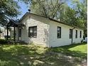 Side view of the home showcasing white brick exterior, trimmed windows, and yard at 3342 Foltz St, Indianapolis, IN 46221