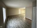 Spacious living room featuring modern flooring, ample natural light, and neutral paint at 3628 Breen Dr, Indianapolis, IN 46235