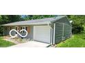 Side view of a single-story home with gray siding, an attached garage, and a paved driveway at 5 Fairlane East Ct, Danville, IN 46122