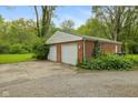 Spacious two-car garage with a brick exterior and ample parking space at 502 S Harrison St, Alexandria, IN 46001