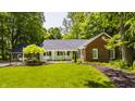 Charming brick home with a manicured lawn and a tree in front, creating a picturesque and inviting curb appeal at 535 W 93Rd St, Indianapolis, IN 46260