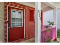 Inviting front entrance with a red door, brick accents, and charming pink railing detail at 539 Deer Trail Dr, Indianapolis, IN 46217