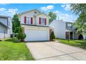 Lovely two-story home with a spacious driveway, red shutters, and green front yard at 539 Deer Trail Dr, Indianapolis, IN 46217