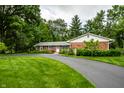 Well-maintained brick home features a lush lawn and a paved driveway, offering an attractive exterior at 5415 Kilmer Ln, Indianapolis, IN 46250