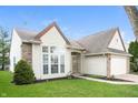 Well-maintained home showcasing brick accents, manicured landscaping and an attached two-car garage at 6121 Jester Ct, Indianapolis, IN 46254