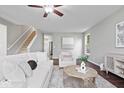 Comfortable living room featuring hardwood floors, neutral decor, and a staircase at 6528 Abby Ln, Zionsville, IN 46077