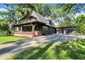 Attractive craftsman-style home with a spacious porch, a balcony, and a detached garage at 710 N Spring St, Greenfield, IN 46140
