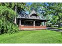 Inviting craftsman-style home featuring a spacious front porch and well-manicured lawn at 710 N Spring St, Greenfield, IN 46140