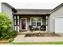 Cozy front porch of this charming home with outdoor furniture and decorative wreath at 73 Suncrest Dr, Greenwood, IN 46143