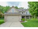 Charming two-story home features a brick-accented garage, manicured lawn, and welcoming curb appeal at 7322 Stones River Dr, Indianapolis, IN 46259