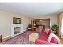 Inviting living room with fireplace, hardwood floors, and an open view to the dining area at 7401 Spring Mill Rd, Indianapolis, IN 46260